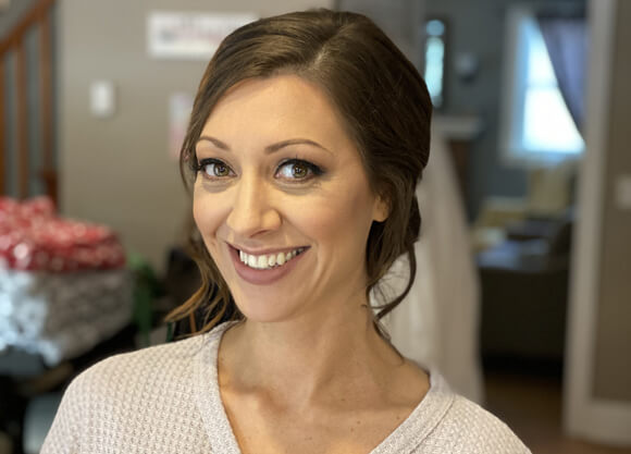 Becca Lucas smiles for the camera while seated