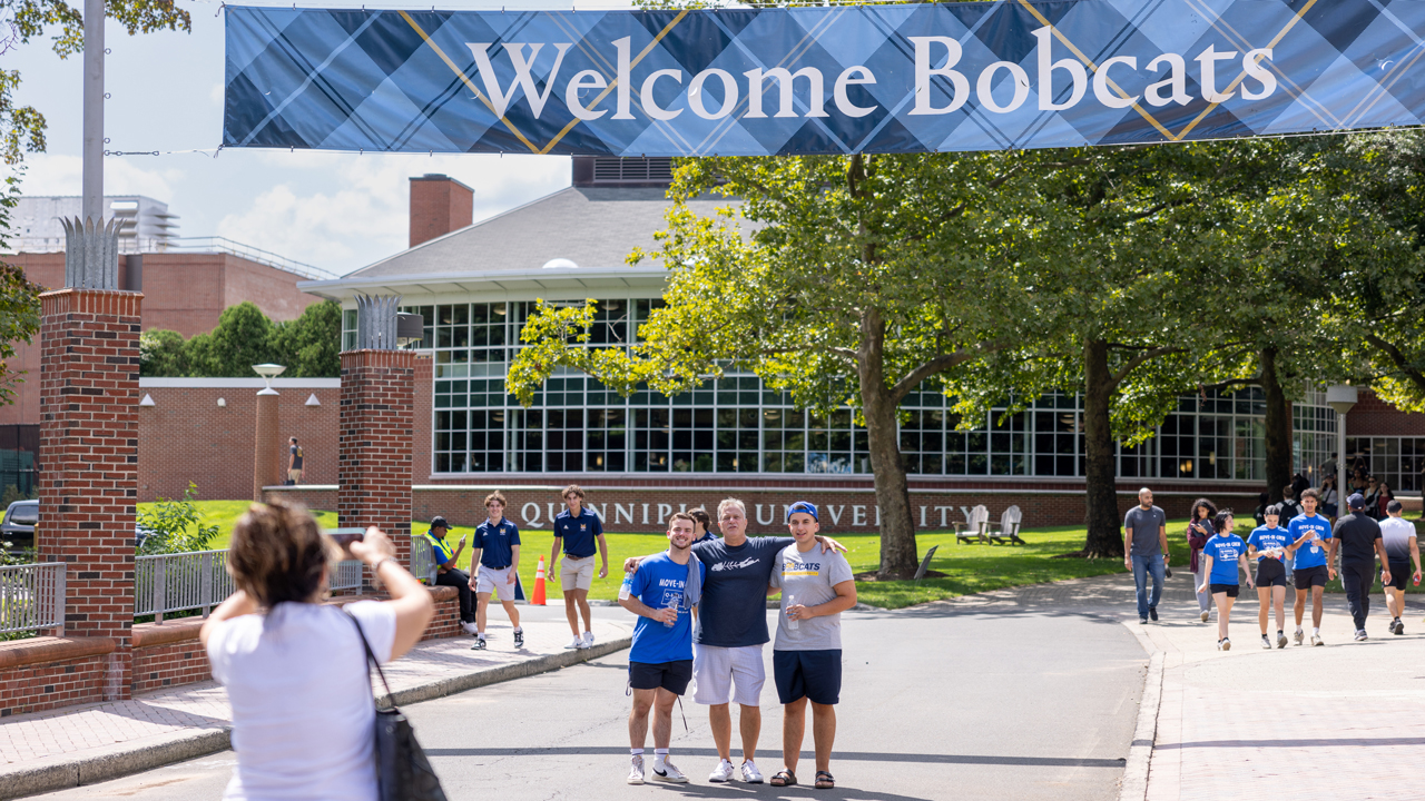 Students stand under Welcome Bobcats banner