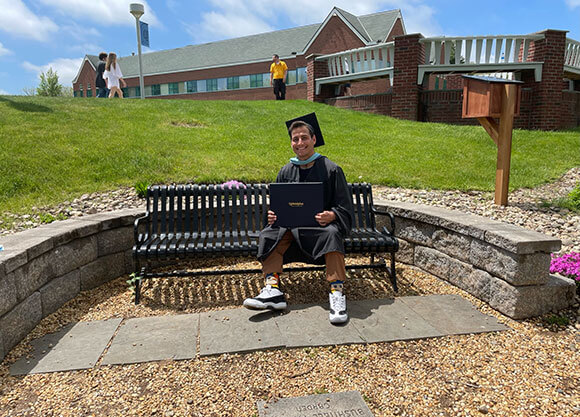 Photo of alumnus Jesse Cala with his degree