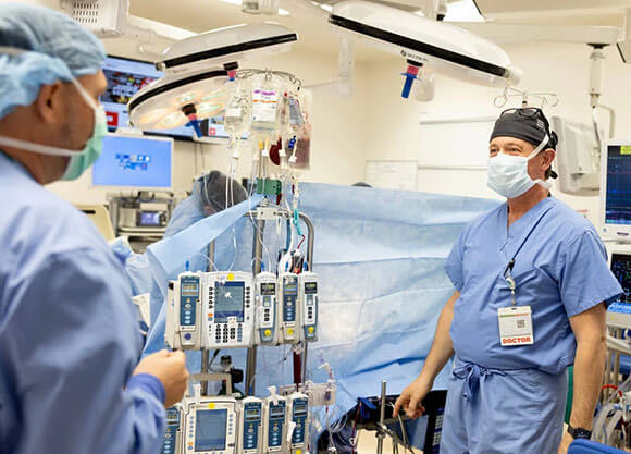 Two doctors conversing in a surgical setting