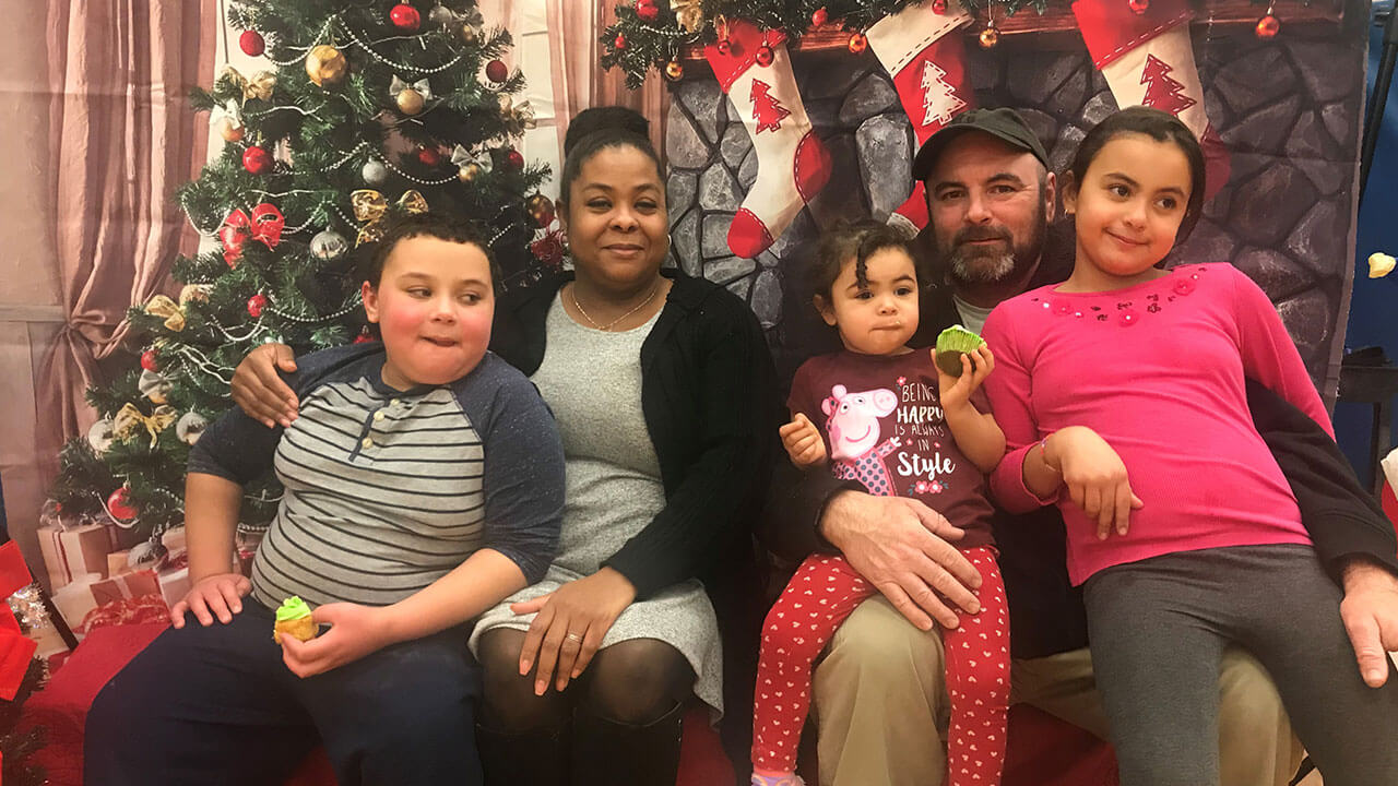 Scott family in front of Christmas decorations