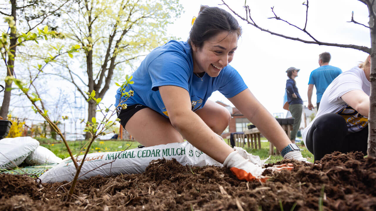 Student volunteer tends to the ASI pollinator garden.