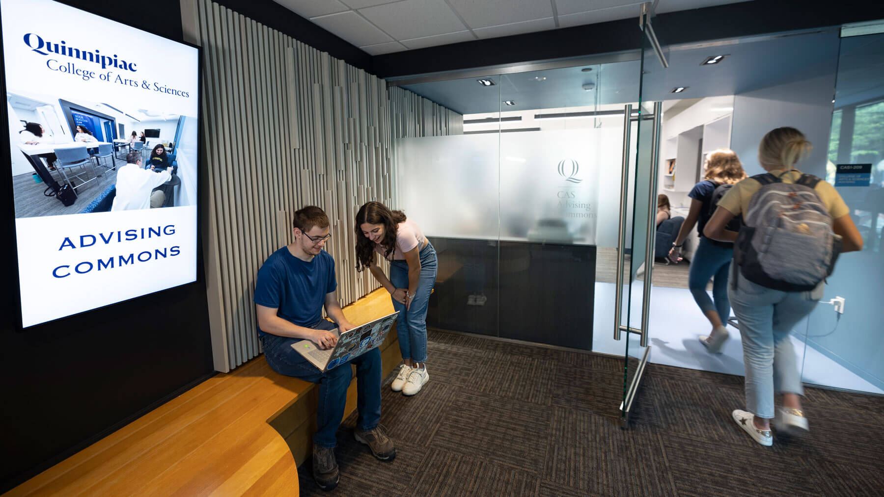 Students working on computers outside of the College of Arts and Sciences Academic Commons.