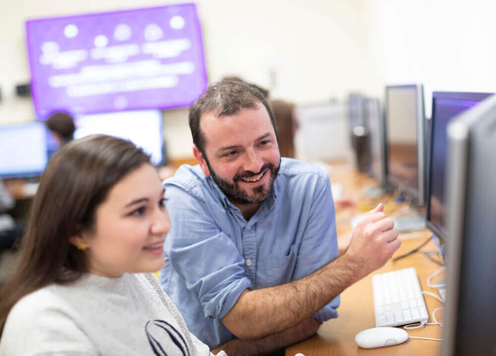 Game design professor Jonah Warren oversees a project a student is working on