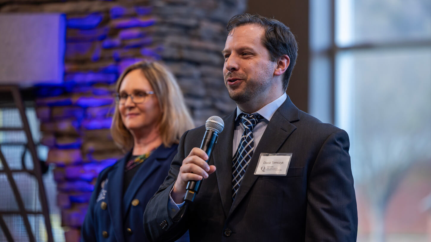 A faculty member gives closing remarks at the pitch competition