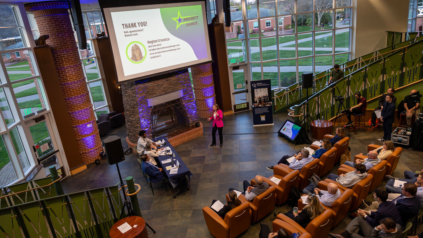 Students watch their peers participating in the pitch competition.