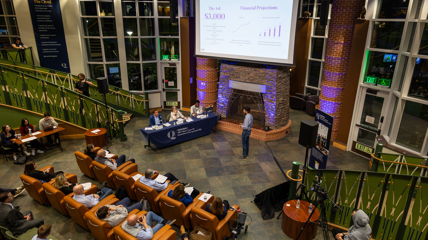 Students watch their peers participating in the pitch competition.