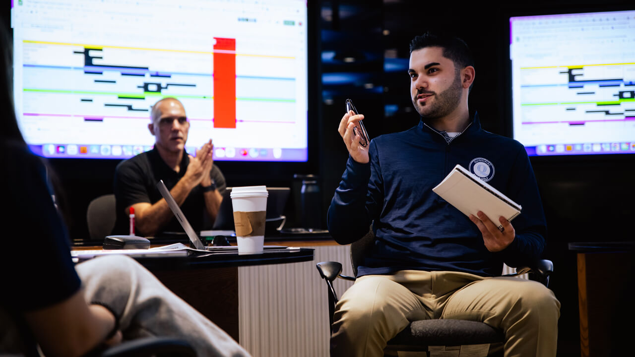 Students collaborating during a meeting for The Agency in the School of Communications.