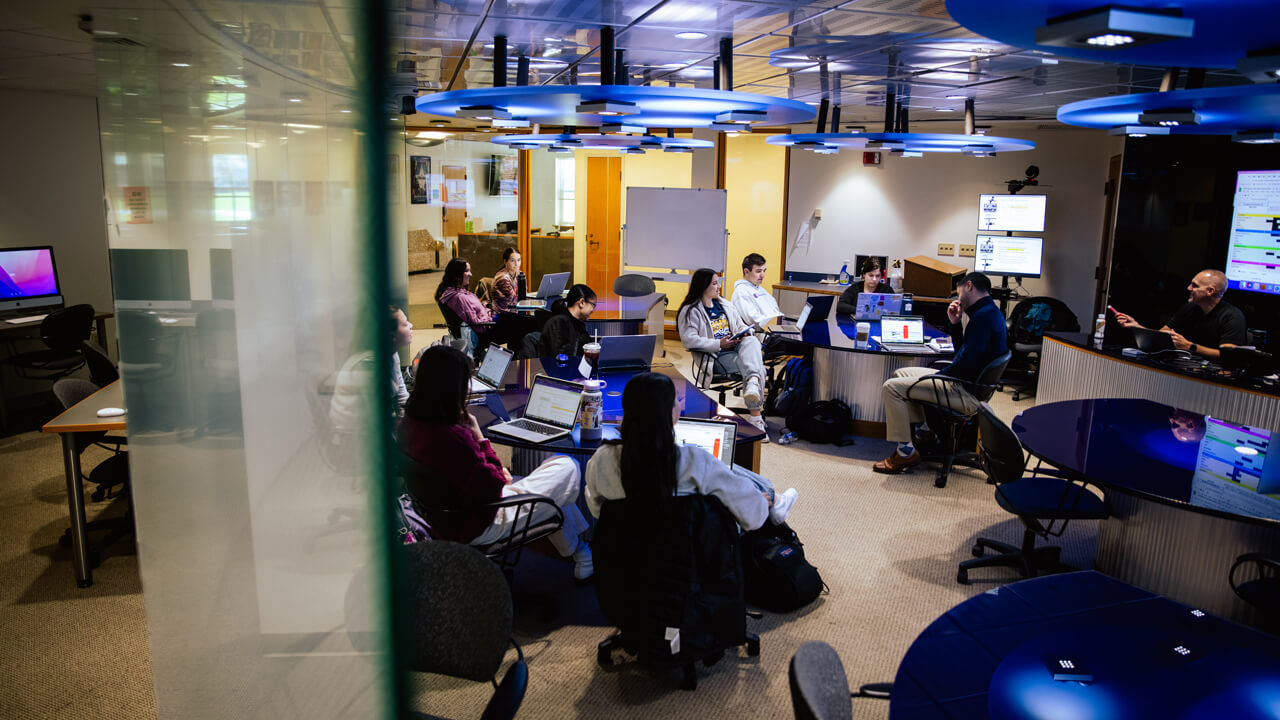 Student members of The Agency gather to discuss advertising tactics in the School of Communications.