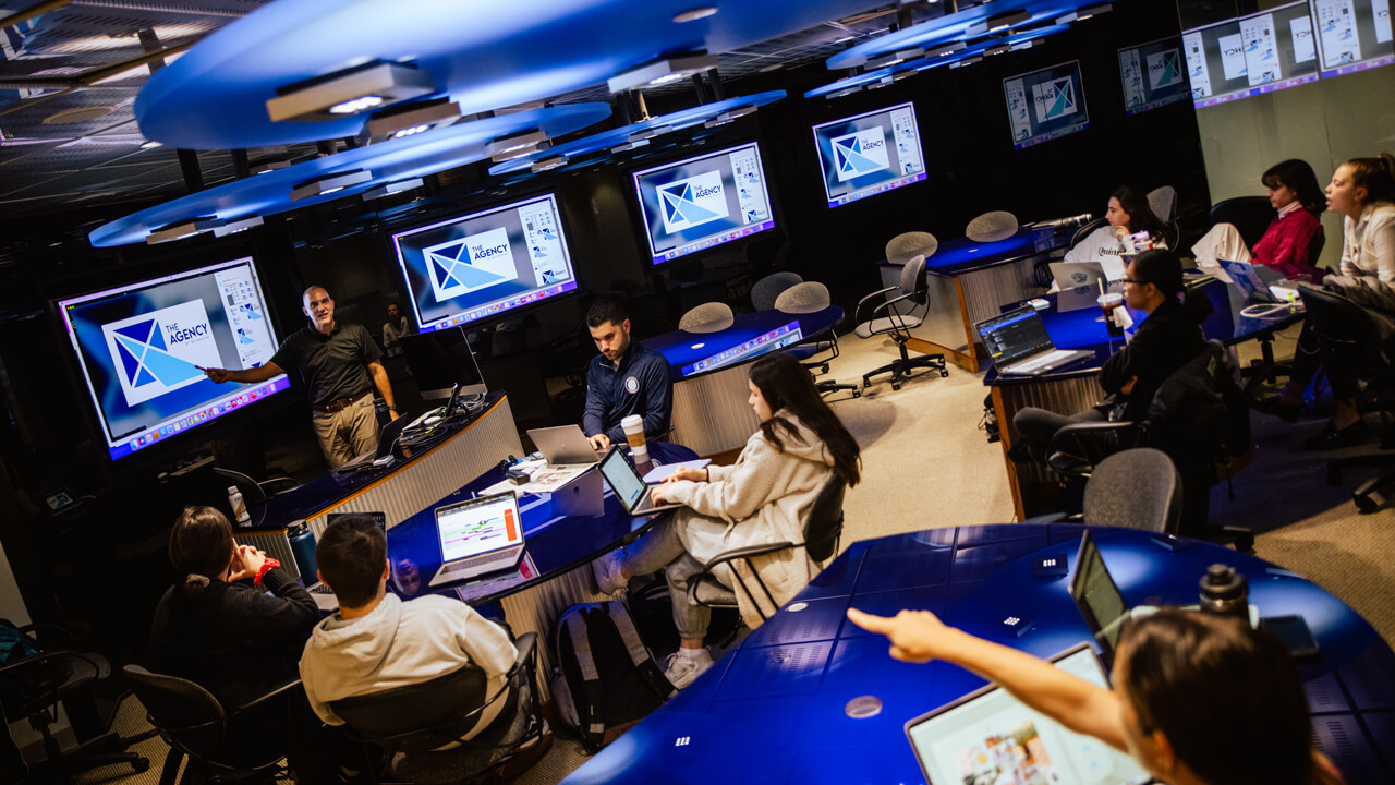 Student members of The Agency gather to discuss advertising tactics in the School of Communications.