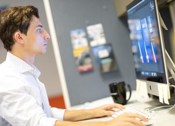 a man looks at a computer screen