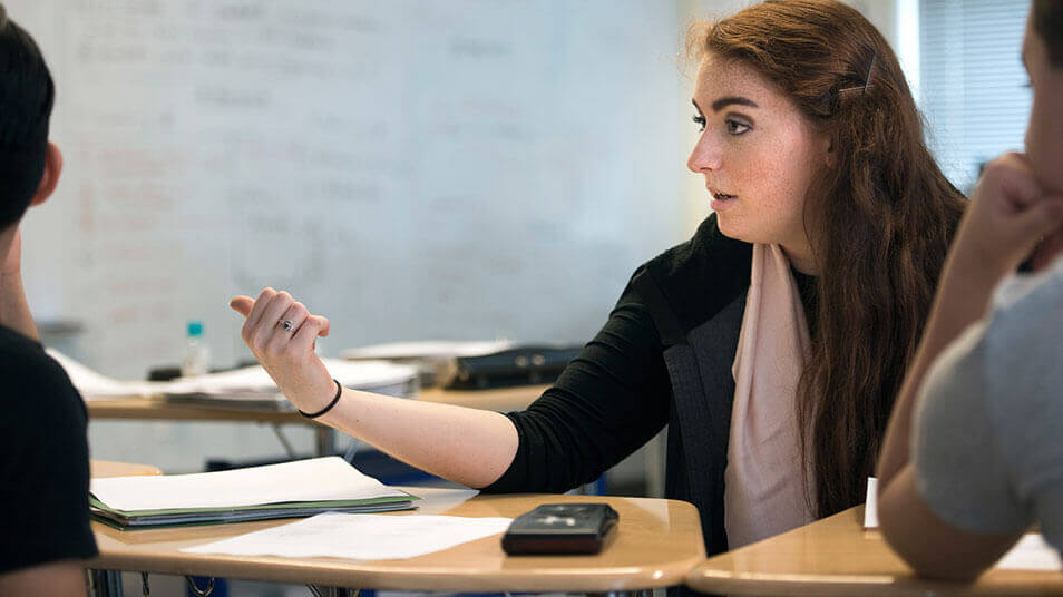 A School of Education student teaches math to high school students at a New Haven high school