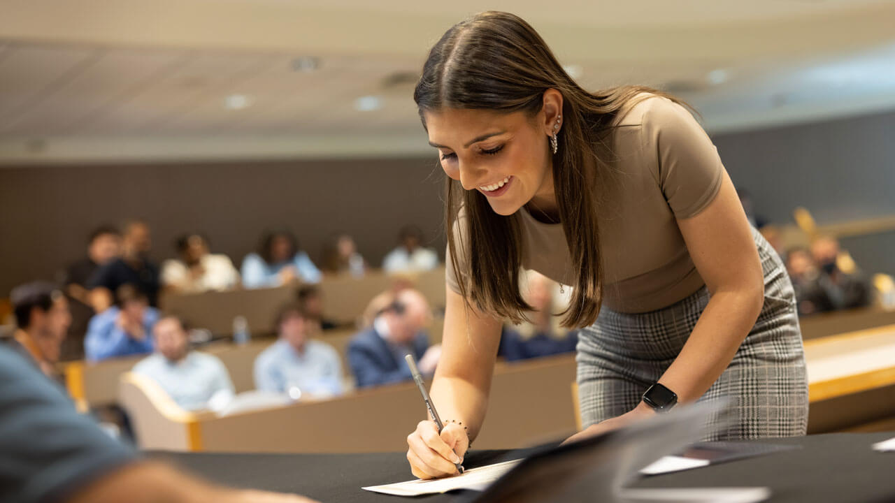 A student signs the Pledge of the Computing Professional.