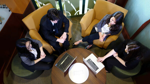 Quinnipiac graduate students in a QU Online photo session in the Carl Hansen Student Center Piazza.