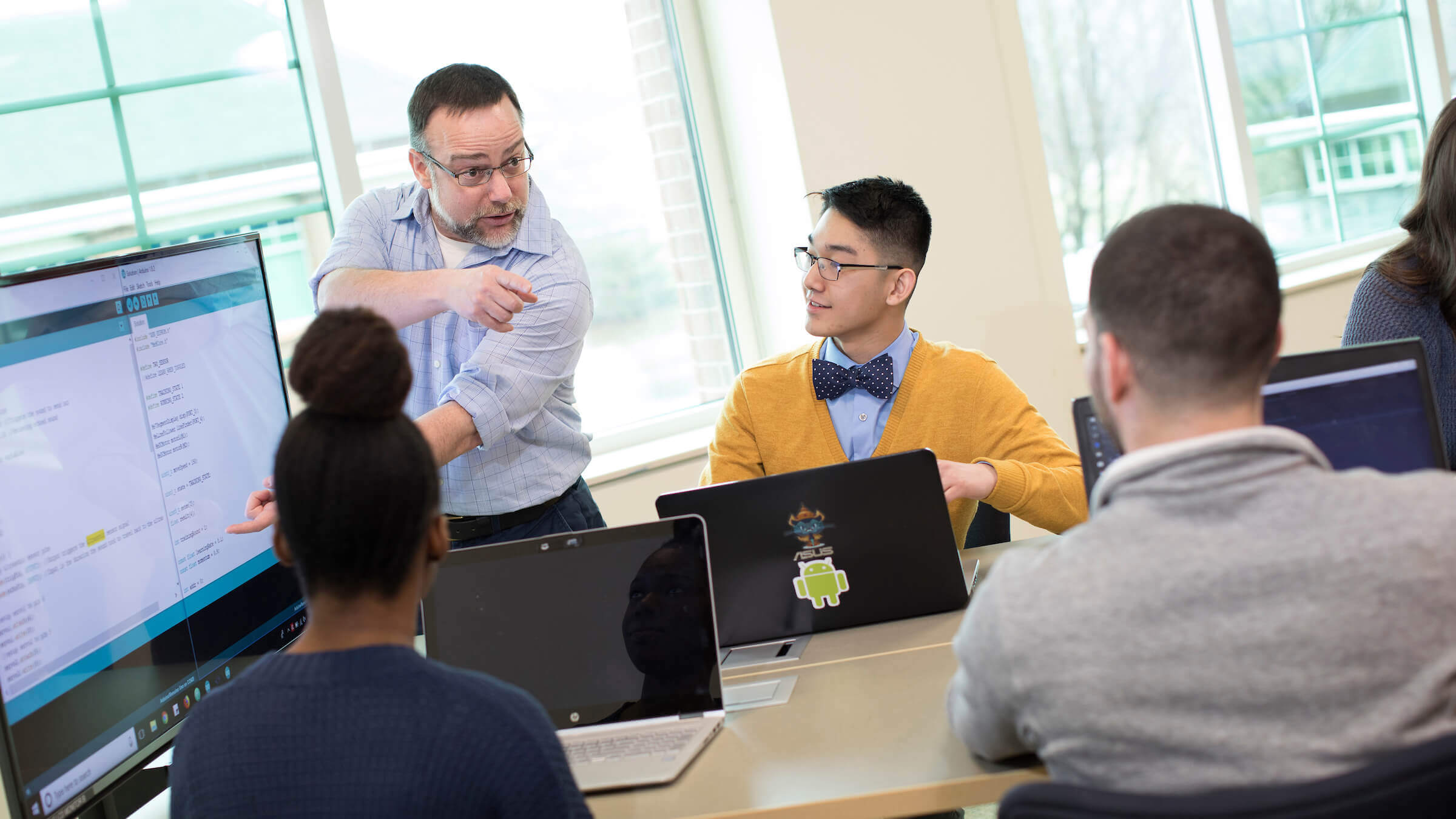 Professor lectures student in a classroom