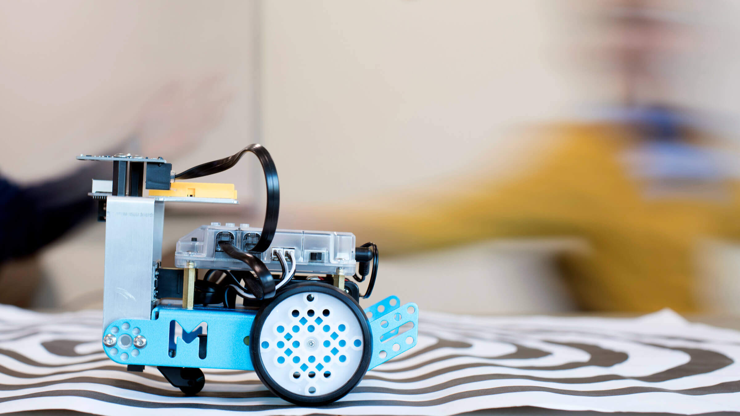 A robot on a desk in a classroom