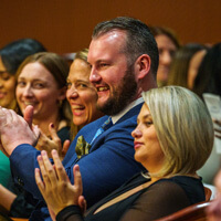 Jar Flanagan sitting in a crowd at pinning ceremony