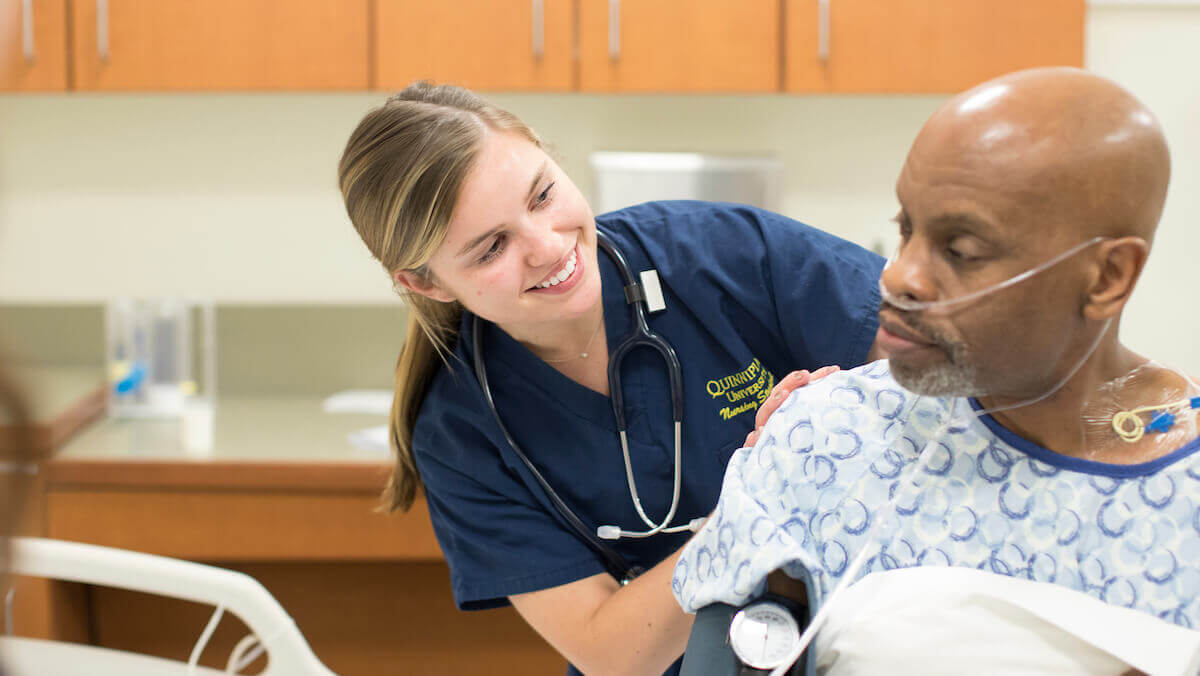 Quinnipiac Nursing student during a simulation lab involving a standardized patient.