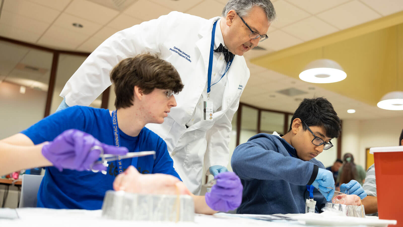 High school students work with a Quinnipiac professor and students during a health exploration camp.