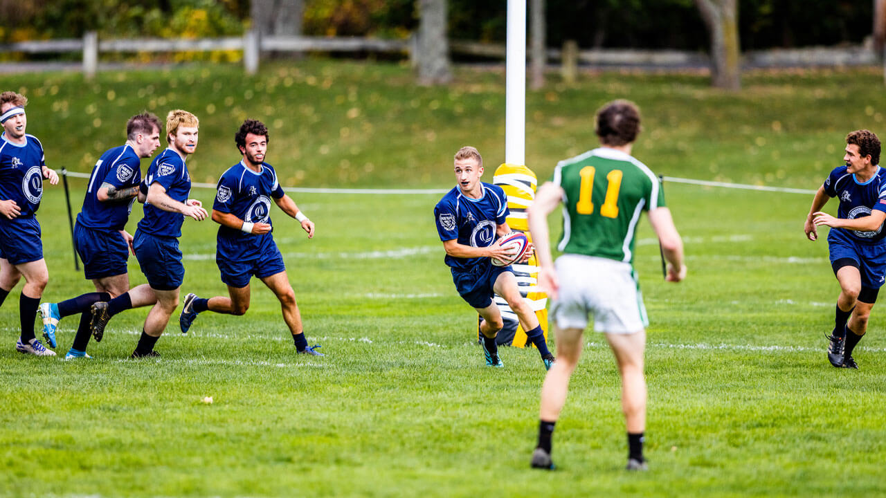 Chasing student down the field with ball