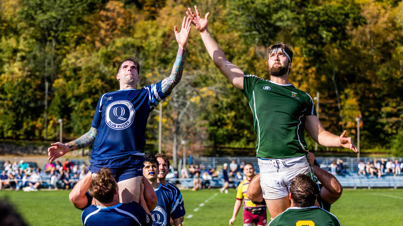 Men leaping in the air to catch ball