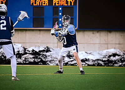 2 men throwing lacrosse ball to each other