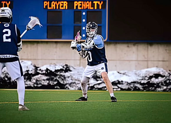 2 men throwing lacrosse ball to each other