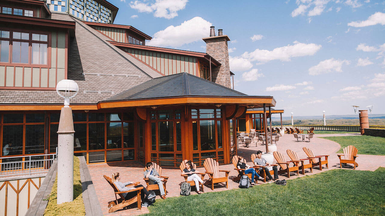 Students sit on Adirondack chairs outside the Rocky Top Student Center.