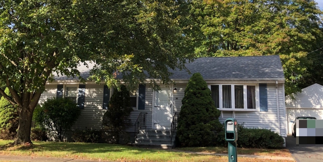 White ranch house with shrubbery planted in front on 124 New Road