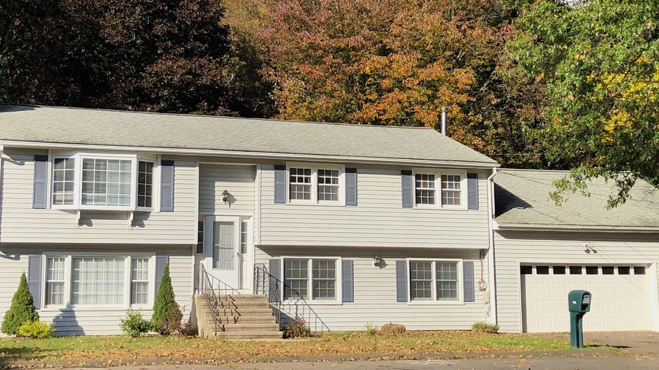 White raised ranch with one car garage on 130 Lucien Drive