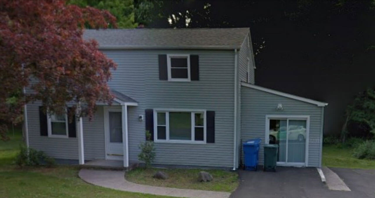 Blue house with a walkway leading up to front door and tree on the left side of house on 131 New Road