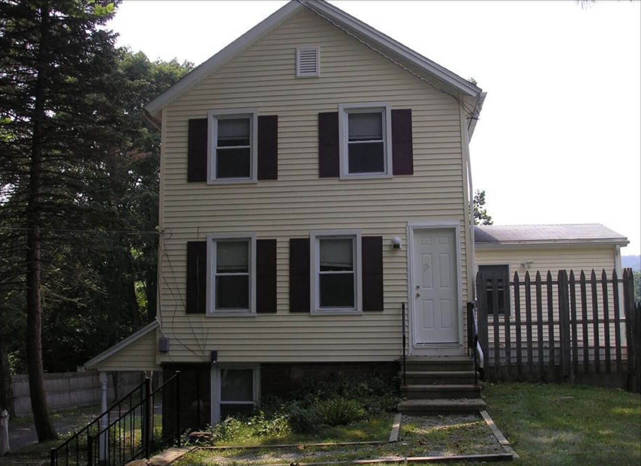 Yellow two story house on 204 New Road