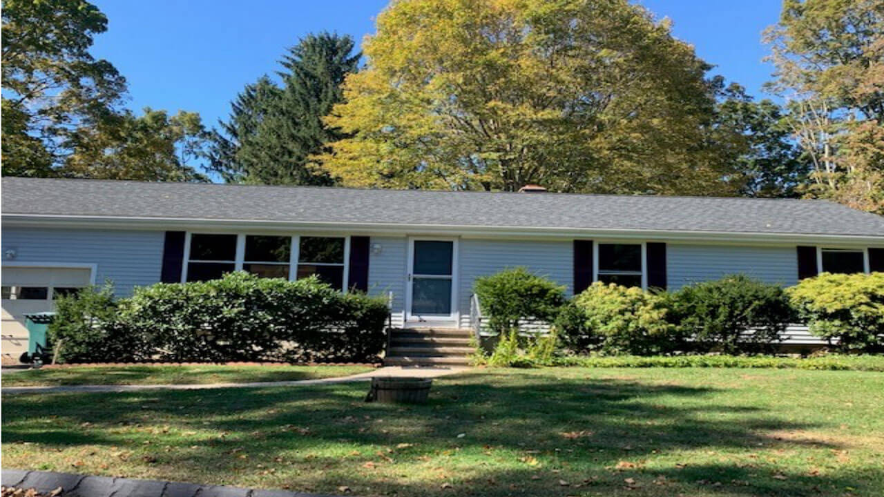 White house ranch with shrubbery on 90 Lucien Drive