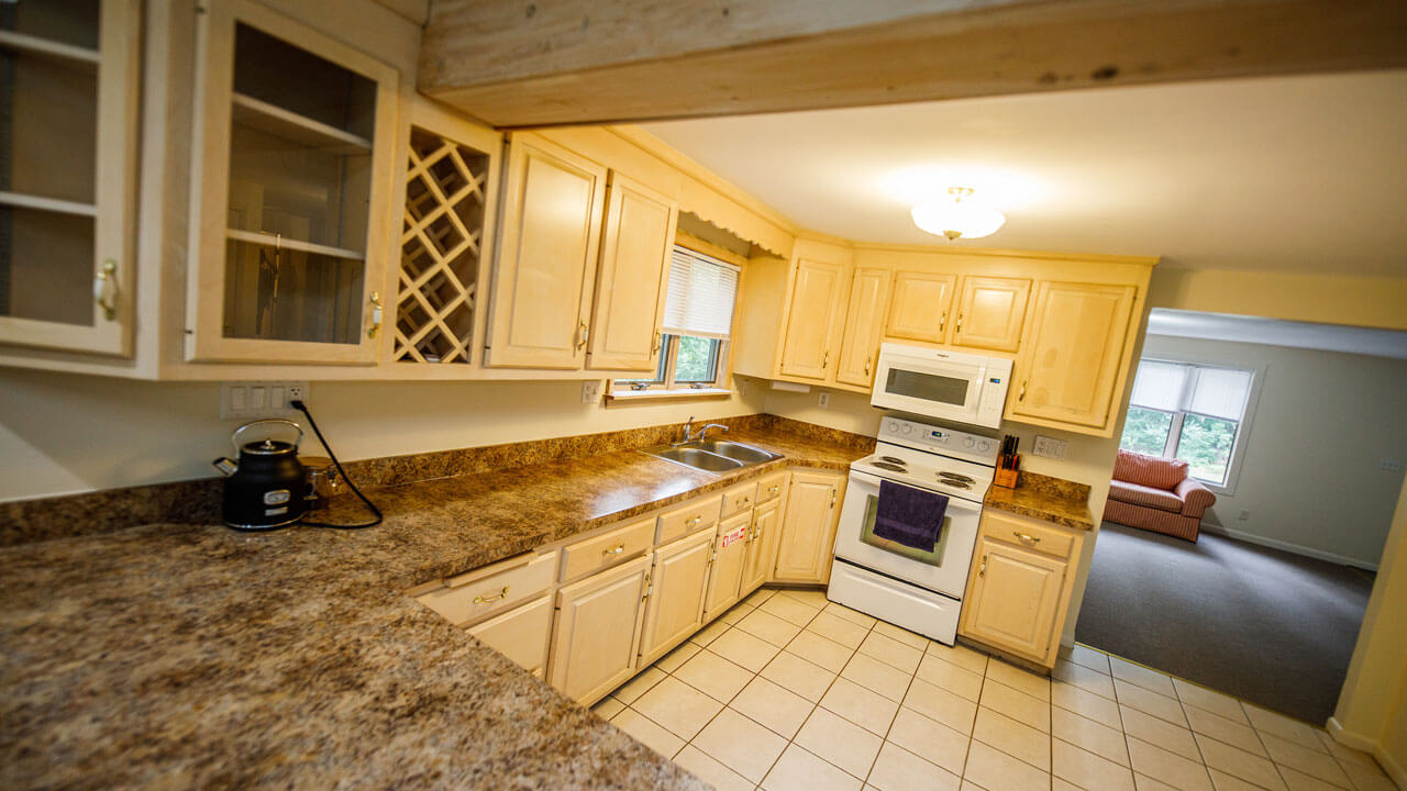 Completed kitchen with much counter space, seating area, and stove