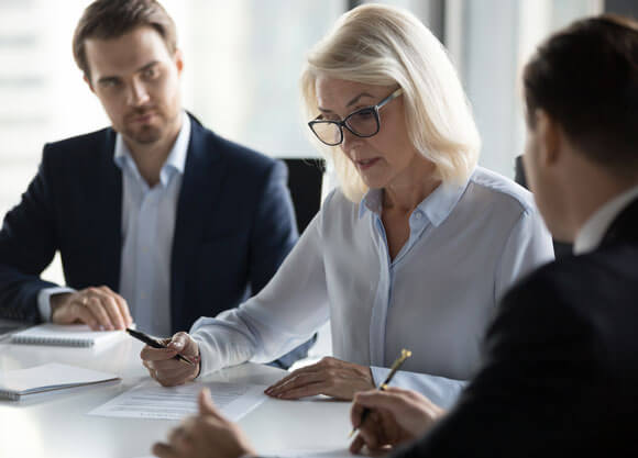 Business professionals reviewing financial paperwork.