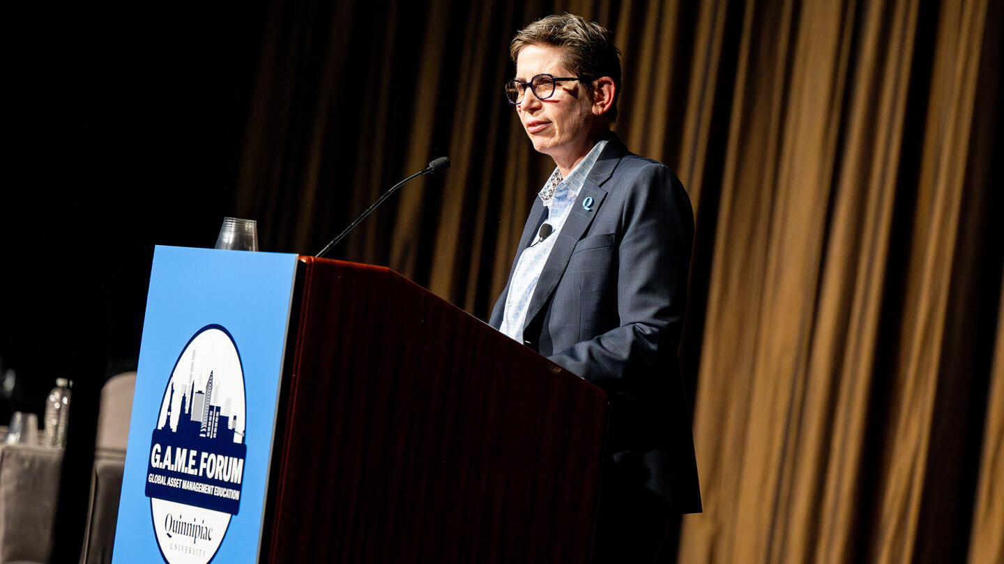 Provost Debra Liebowitz speaking at a podium during opening ceremony at GAME Forum.