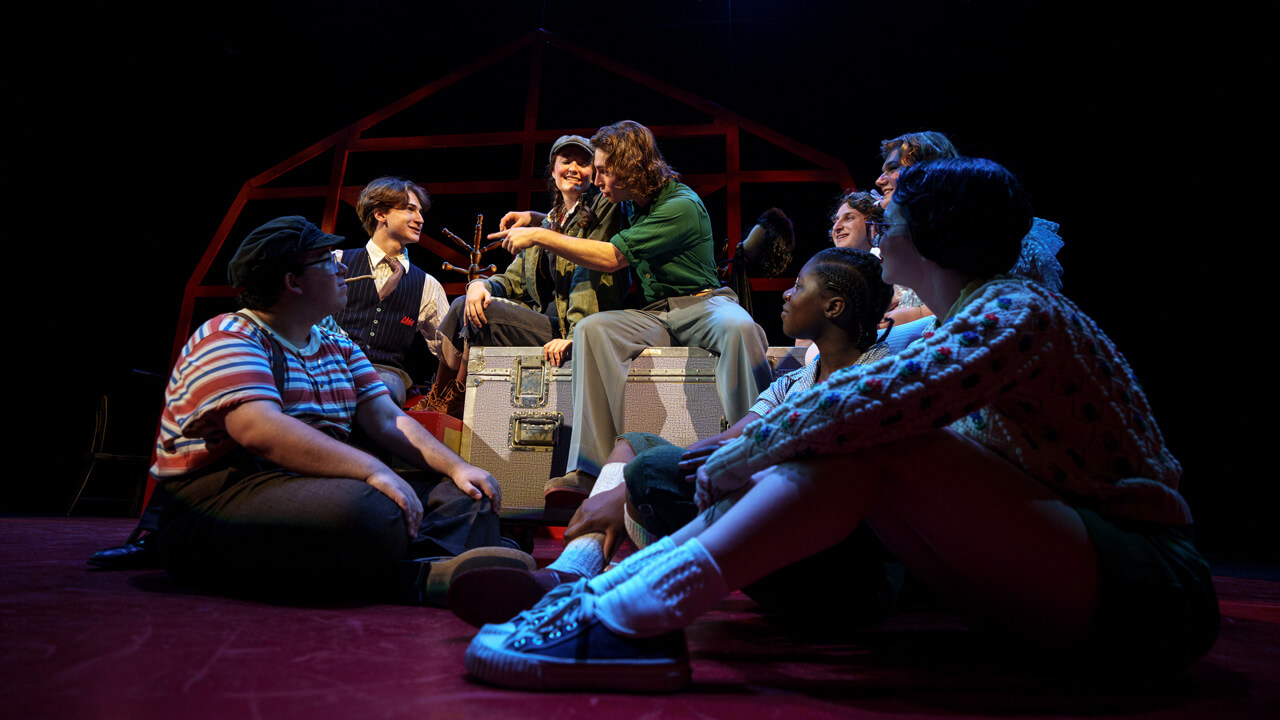 the full cast at posing at the end of a musical number